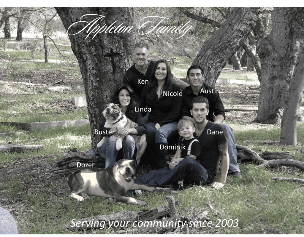 A family posing for a picture in the woods.