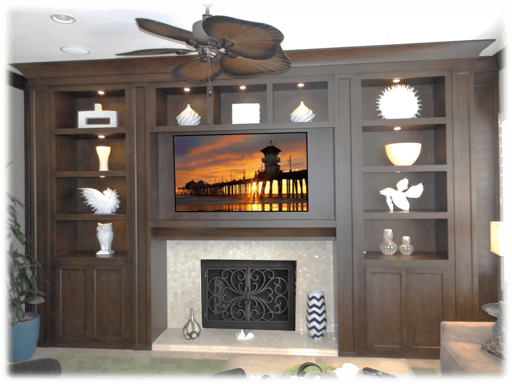 A living room with a fireplace and built in bookcases.