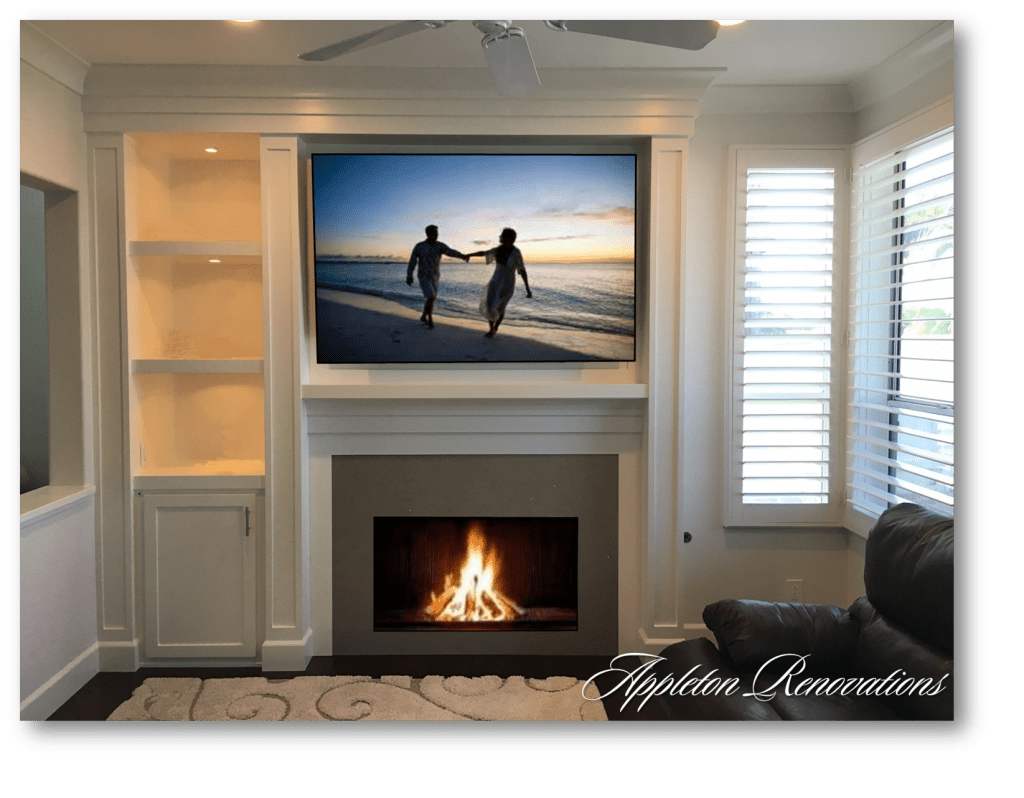 A living room with a fireplace and a flat screen tv.