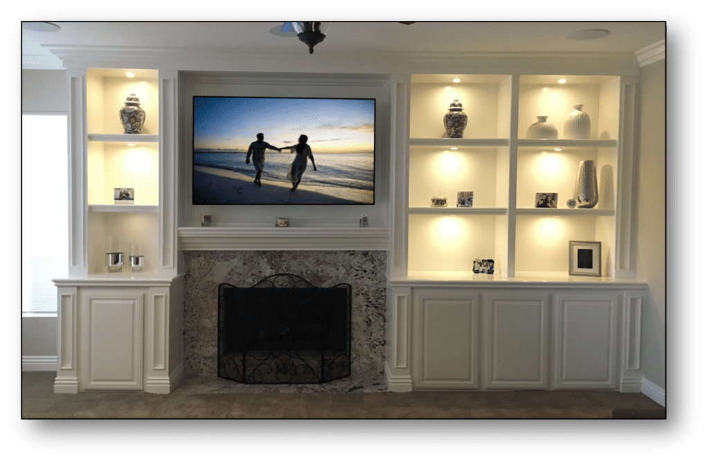 A flat screen tv mounted to the wall above a fireplace.