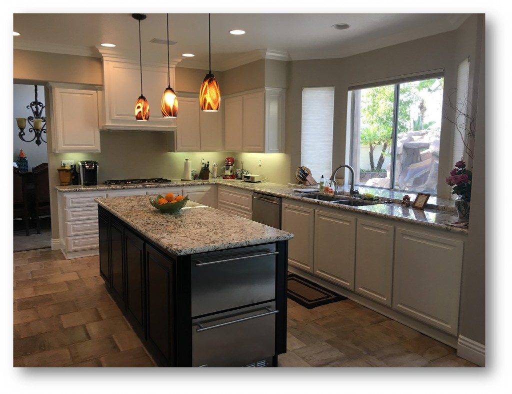 A kitchen with a large island and granite counter tops.