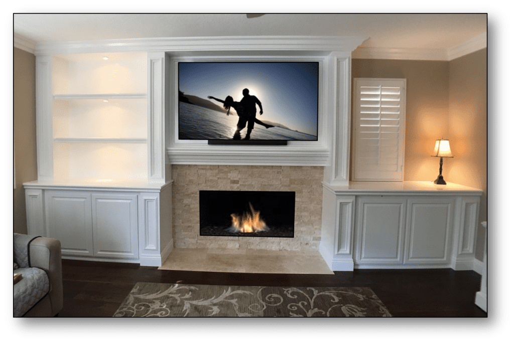 A flat screen tv mounted above a fireplace.