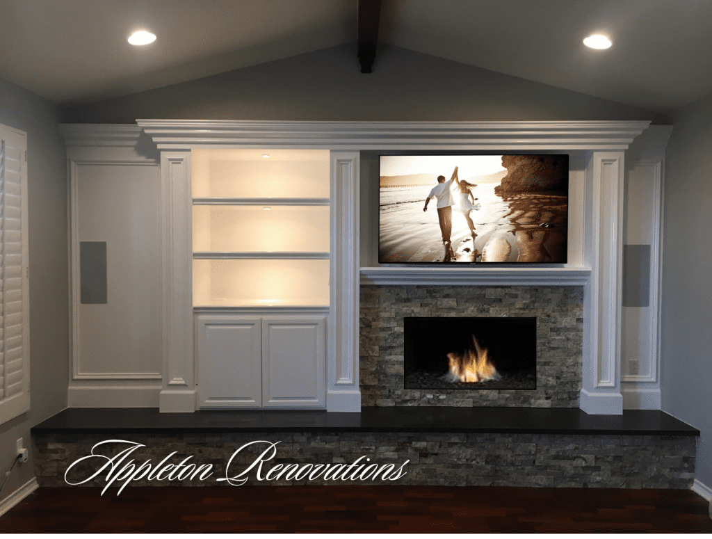 A fireplace with a television mounted above it.