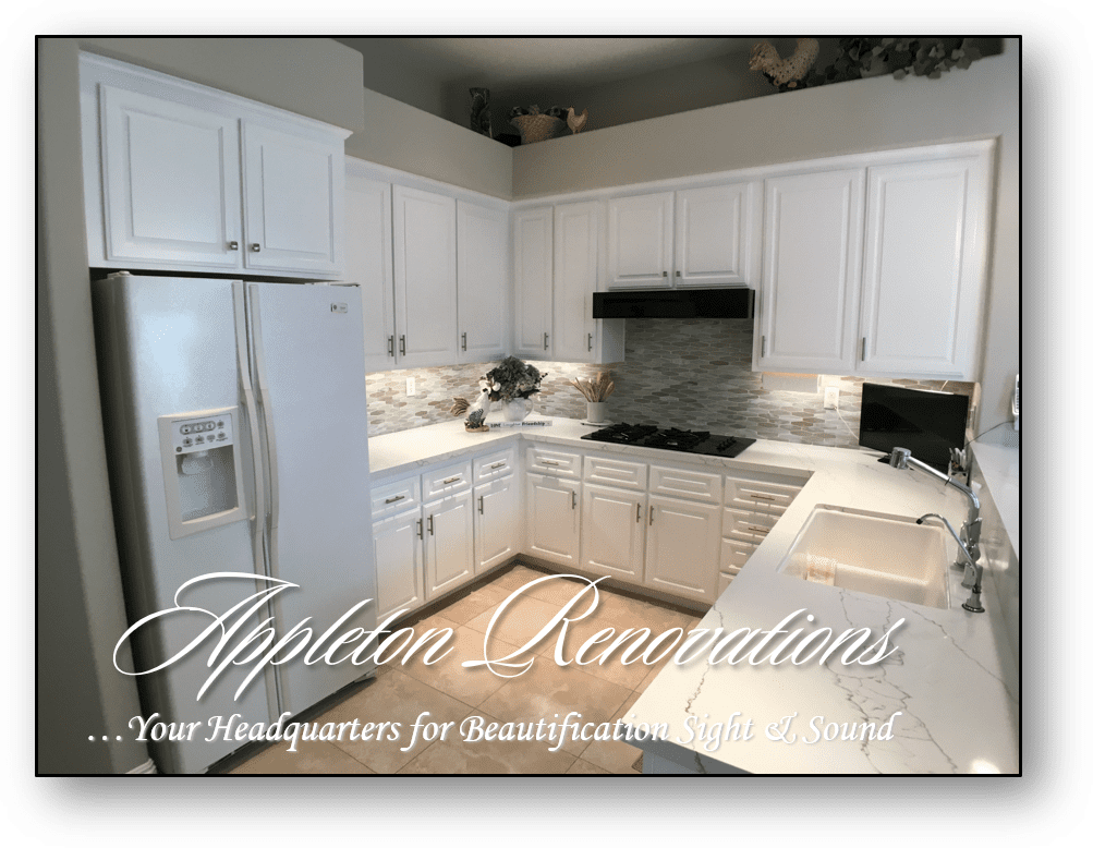 A kitchen with white cabinets and granite counter tops.