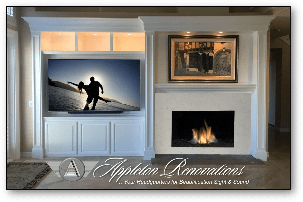 A fireplace with a television above it and a picture of someone skiing.