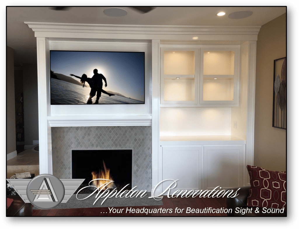 A television mounted on the wall above a fireplace.