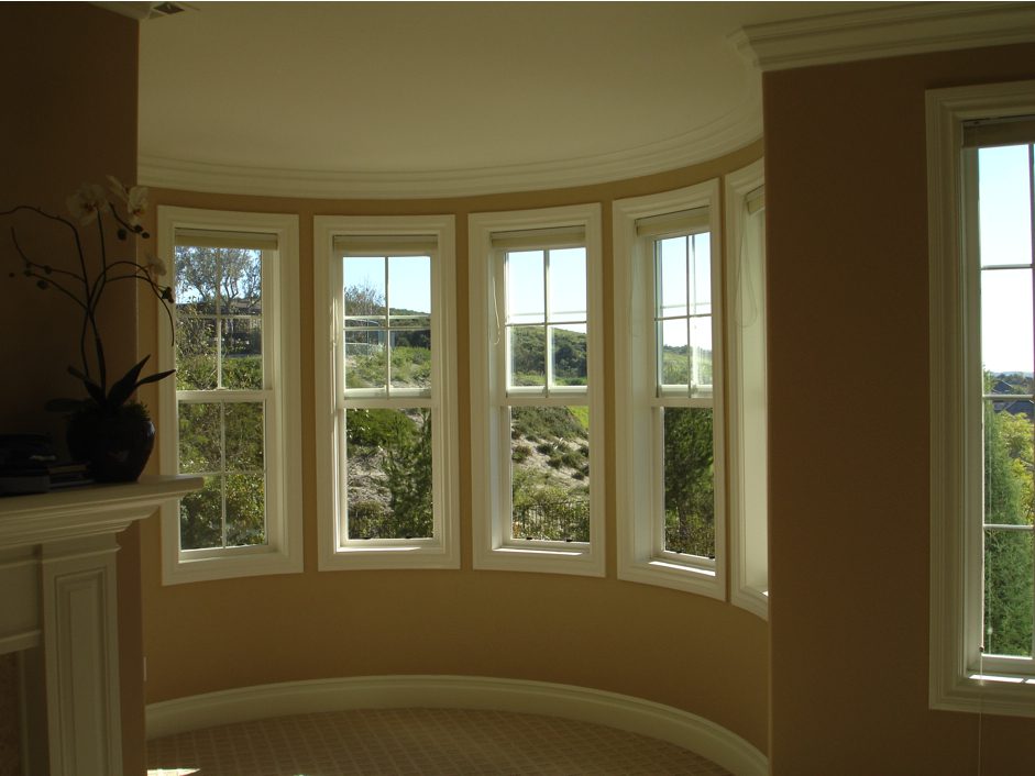 A room with many windows and a fireplace