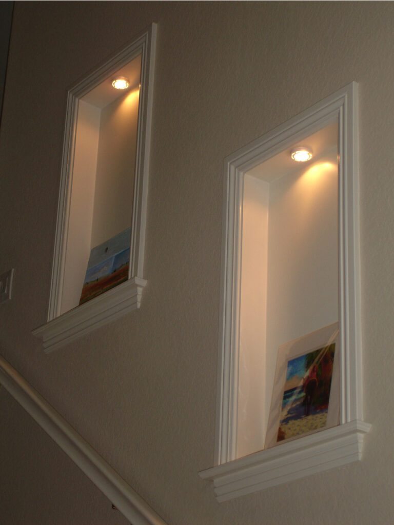 Two recessed lights on the wall above a staircase.