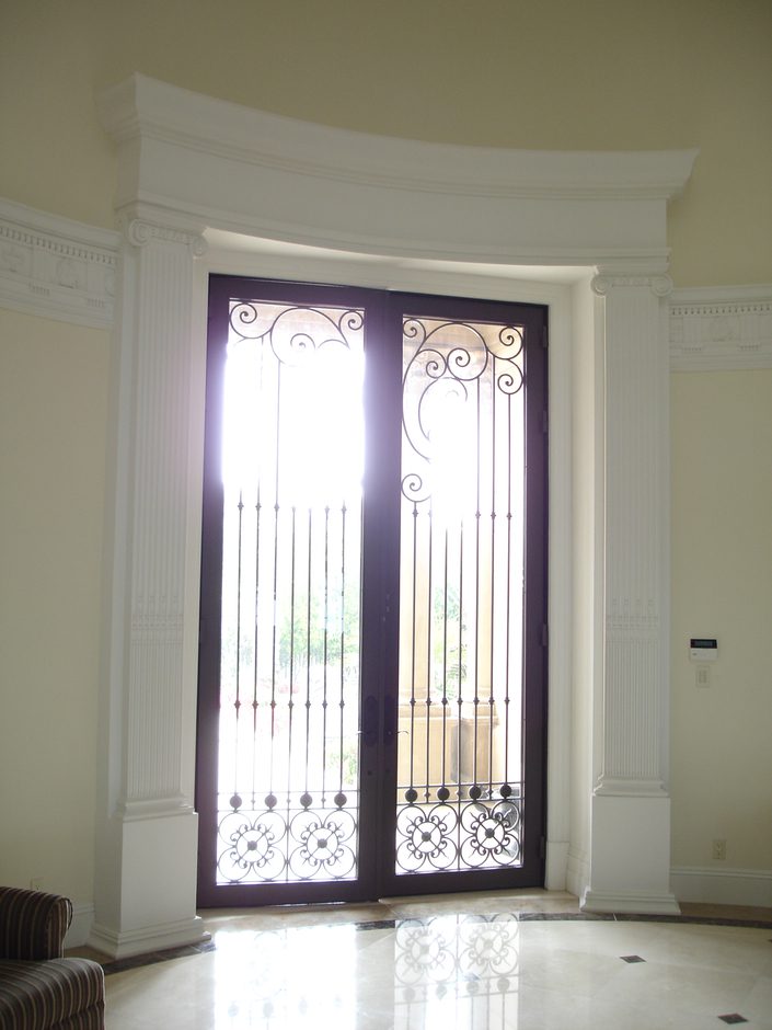 A window with a metal grill in the middle of it.