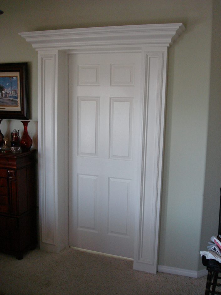 A white door with two panels and a crown molding.