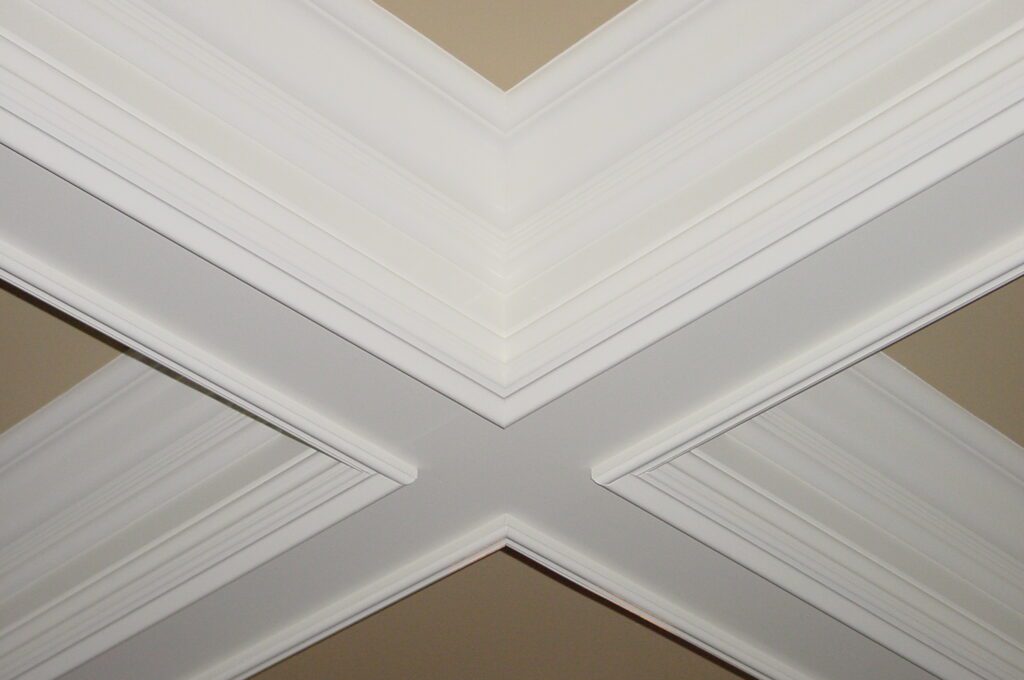 A ceiling with two different types of white paint.