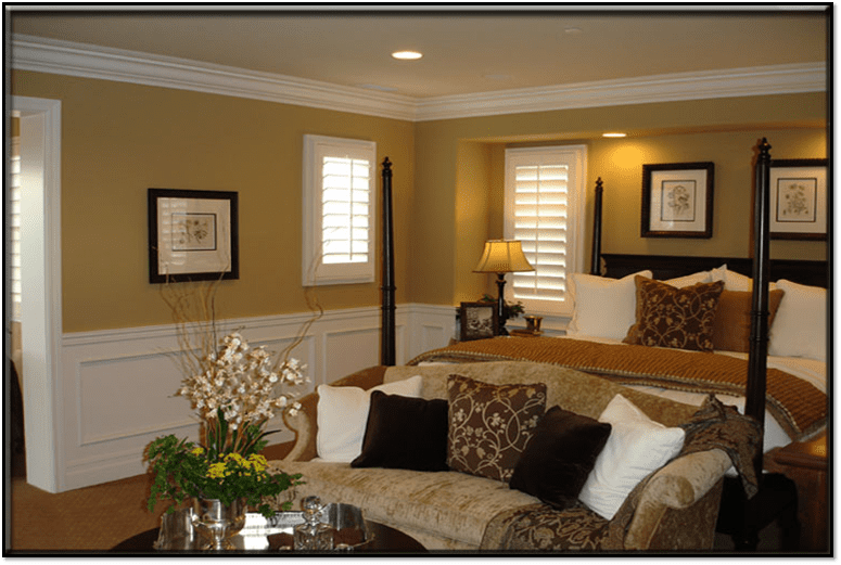 A bedroom with a couch, chair and table.