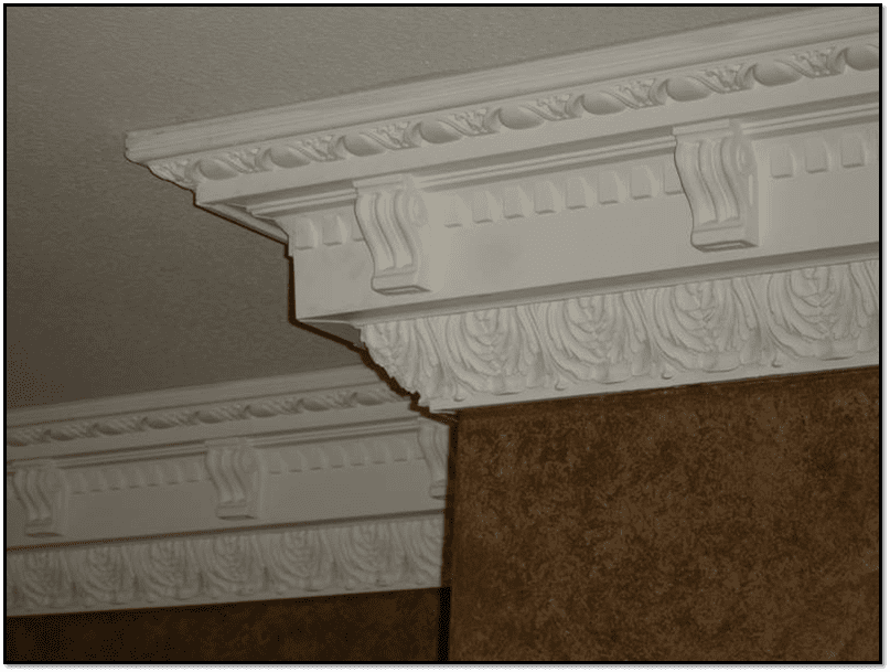 A close up of the corner of a room with some kind of decorative molding.