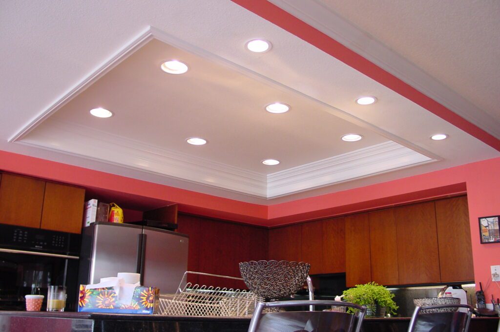 A kitchen with red walls and white ceiling.