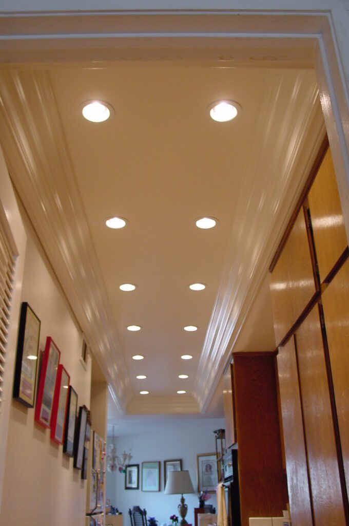 A hallway with many lights on the ceiling.