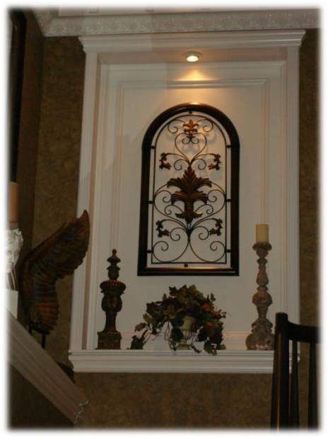 A fireplace with a wrought iron window above it.