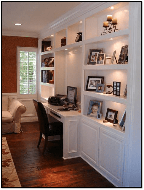 A desk with a chair and pictures on the wall.