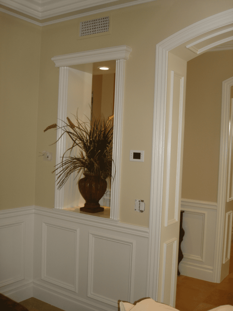 A vase of flowers in the corner of a room.