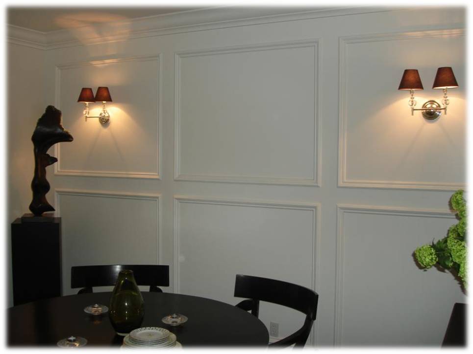 A dining room with white walls and black table.