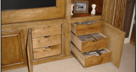 A wooden entertainment center with drawers and shelves.