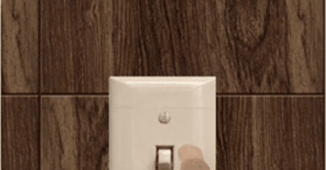 A person is holding on to the light switch.