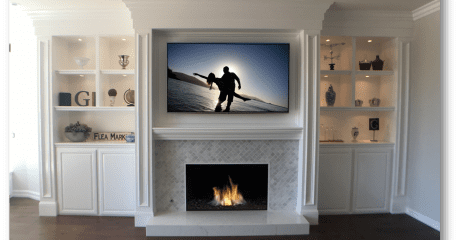 A fireplace with a flat screen tv above it.