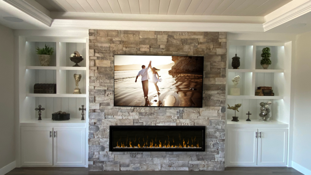 A fireplace with a television mounted above it.