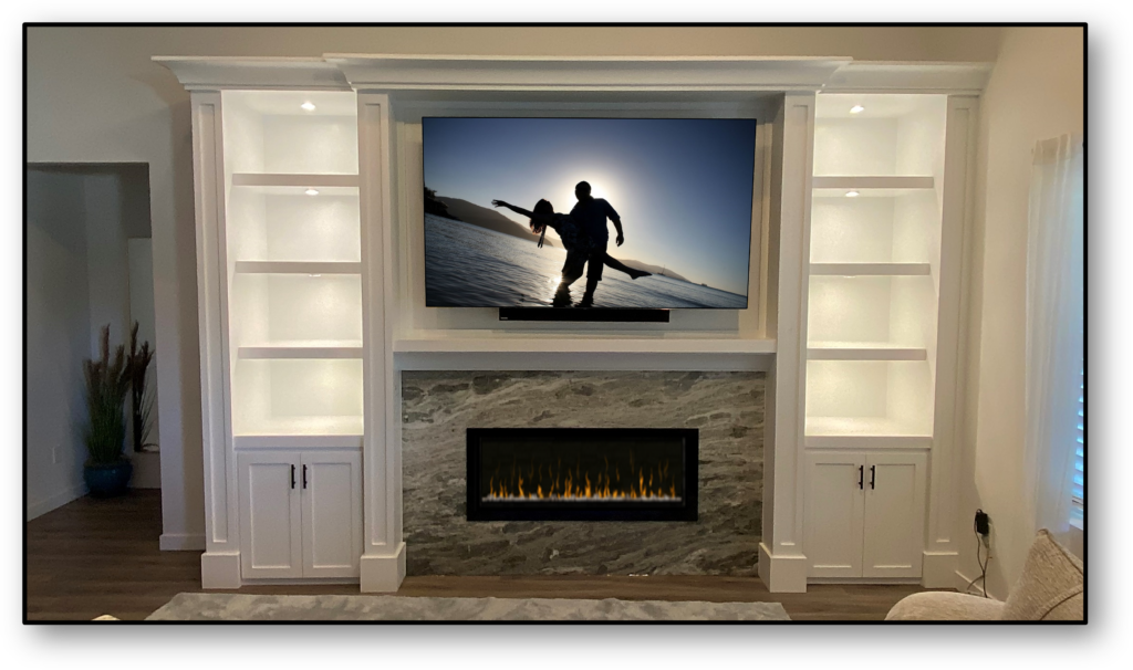 A flat screen tv mounted above a fireplace.